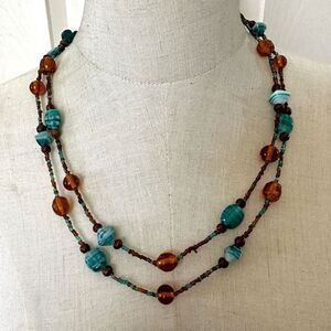 Blue and amber tone long glass beaded necklace